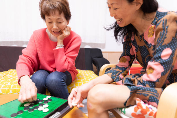 istock Mother and daughter playing board game 1218112809