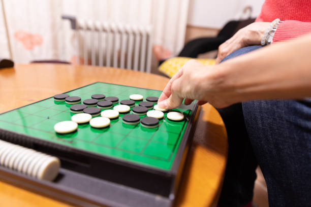 istock Mother and daughter playing board game 1218112895