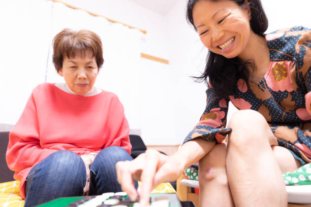 istock Mother and daughter playing board game 1218114601