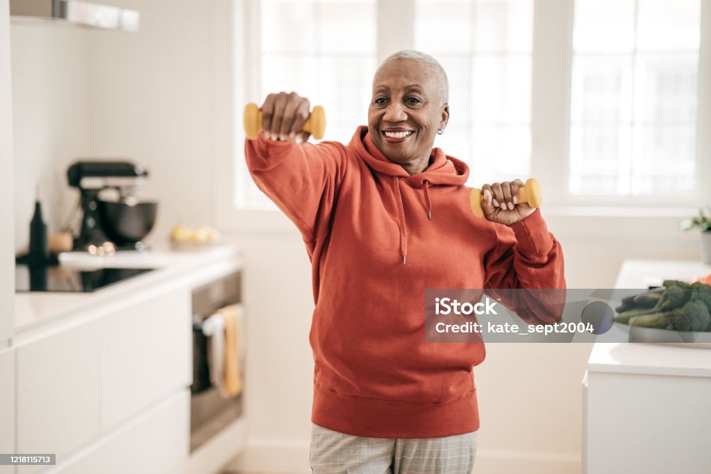 Senior women exercising at home Exercising Stock Photo