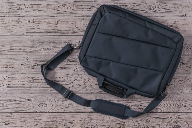 istock Dark blue laptop bag on a wooden background. 1218115717