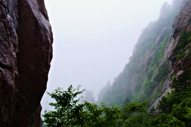 istock Sharp Big Mountains in the Foggy Morning 1218120719