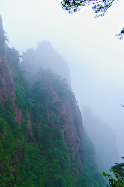 istock Sharp Big Mountains in the Foggy Morning 1218120788