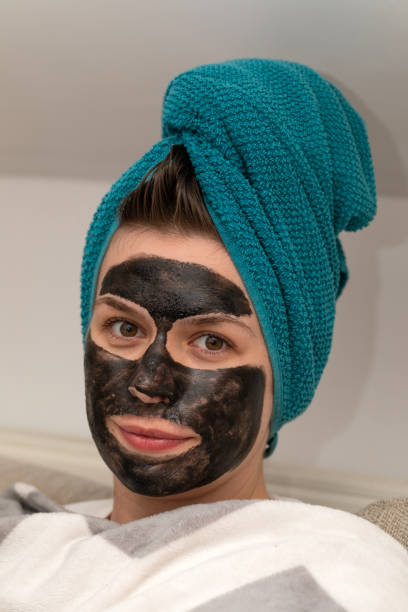 istock Woman with black charcoal face mask 1218123470
