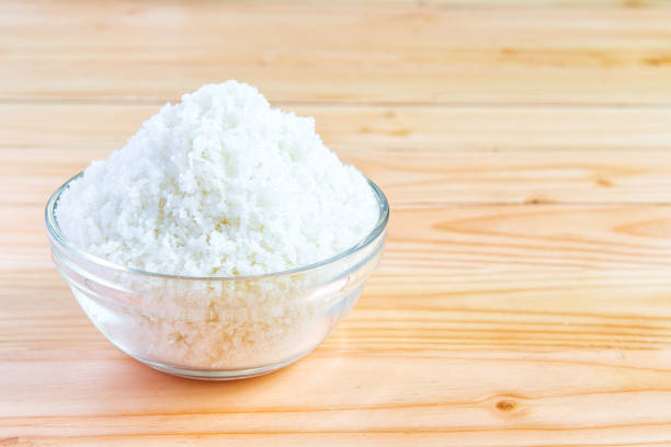Sea salt in bowl on wooden background stock photo