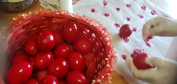 red easter eggs  while painting and polishing in the kitchen homemade