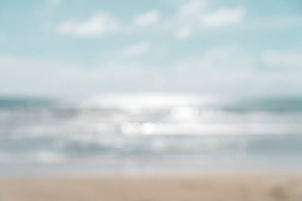 istock Blur summer bokeh beach with sun light and blue sky background. 1218128336