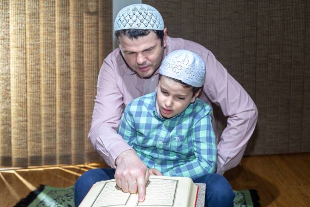 istock Father teaching his son reading Quran in Ramadan 1218130054