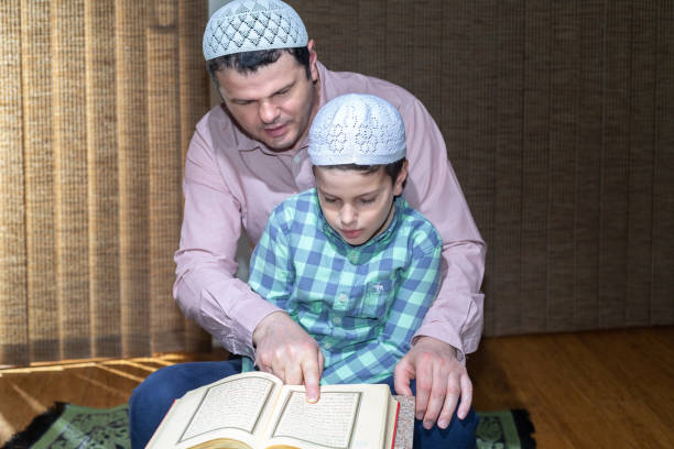 istock Father teaching his son reading Quran in Ramadan 1218130135