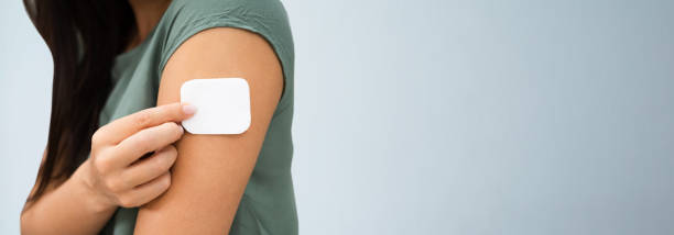 istock Woman Applying Patch On Her Arm 1218132104