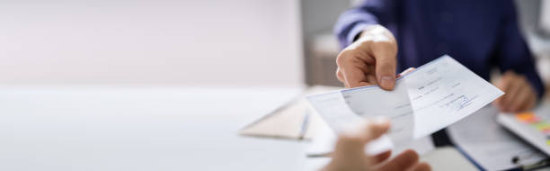 istock Businessperson Hands Giving Cheque 1218132191