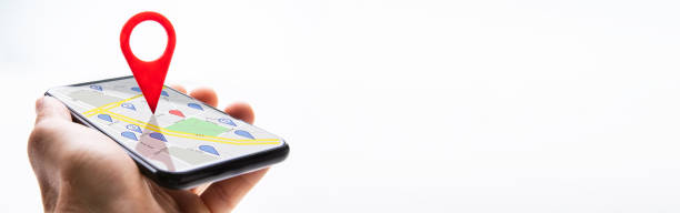 istock Human Hand Holding Cellphone With Navigation Sign 1218132195