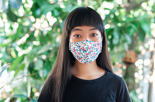 teenage girl wearing fabric mask for protect pm2.5 and Covid-19