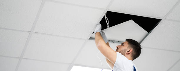 istock Electrician On Stepladder Installs Lighting To The Ceiling 1218132529