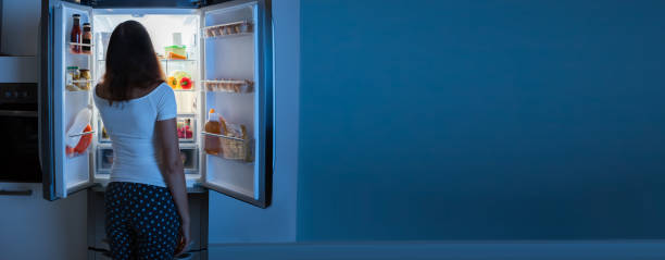 istock Young Woman Looking In Fridge 1218132538