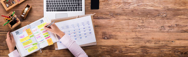 istock Businesswoman Writing Schedule In Calendar Diary 1218132562