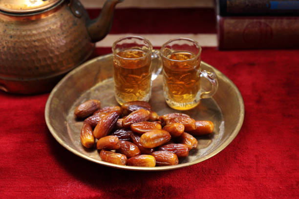 istock Dates fruit and Islamic Book Koran on carpet background, Islamic background in mosque 1218133235