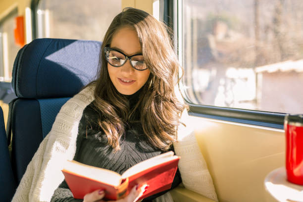 istock Young sad woman looking through the train window. 1218141851