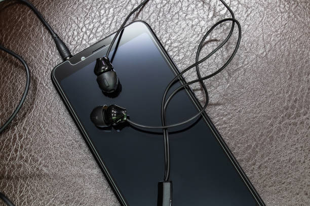 istock Smartphone and earphones placed on leather floor 1218141889