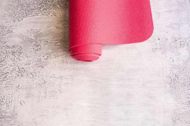 istock Yoga mat on white concrete background 1218142704