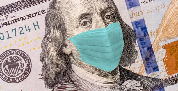 istock Benjamin Franklin With Worried and Concerned Expression Wearing Medical White  Face Mask On One Hundred Dollar Bill 1218142820