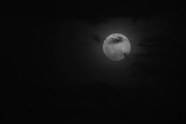 istock Super moon in a black sky with clouds 1218143813