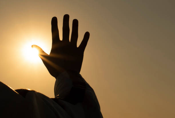 istock silhouette of a man praying at sunset 1218143921