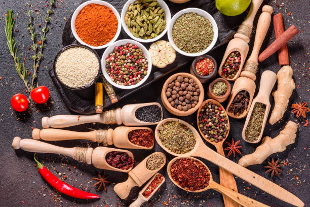 istock Pepper, salt, paprika, basil and other on a dark background 1218144746