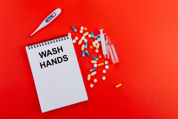 istock Notepad, syringe, ampoules, thermometer on a red background 1218145132