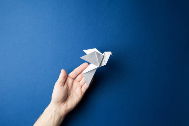 istock Paper pigeon on a blue isolated background. 1218157002