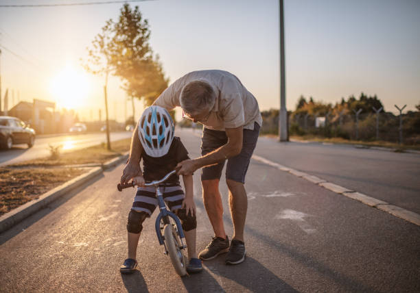 istock Grandfather teaching grandson biking 1218159663