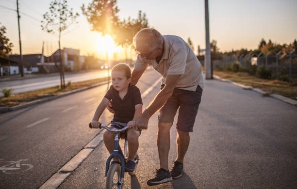 istock Grandfather teaching grandson biking 1218159776