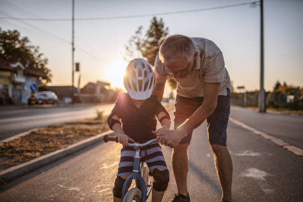 istock Grandfather teaching grandson biking 1218160506