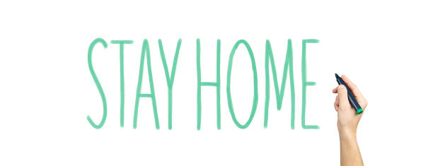 marker in hand with the words stay home. concept on the fight against a pandemic virus. The call to fight the virus through self-isolation at home on white isolated background