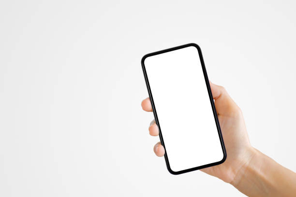 istock Hand holding old black smartphone with gray background. 1218160705