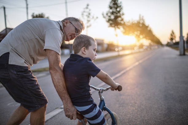 istock Grandfather teaching grandson biking 1218160831