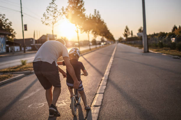 istock Grandfather teaching grandson biking 1218160889