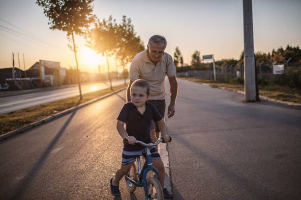istock Grandfather teaching grandson biking 1218160987