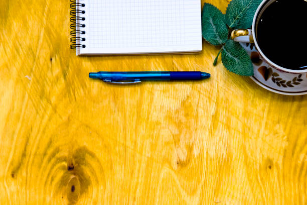 istock Cup of coffe and open notebook on wooden background 1218162092