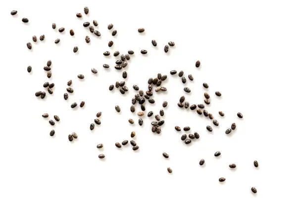 Chia seeds scattered over white background, top view