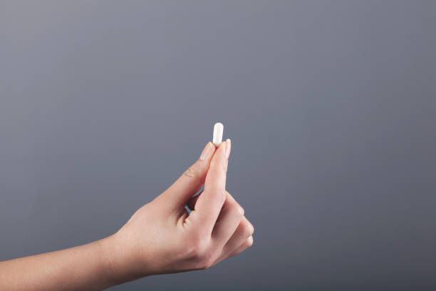 istock woman hand pills 1218166633