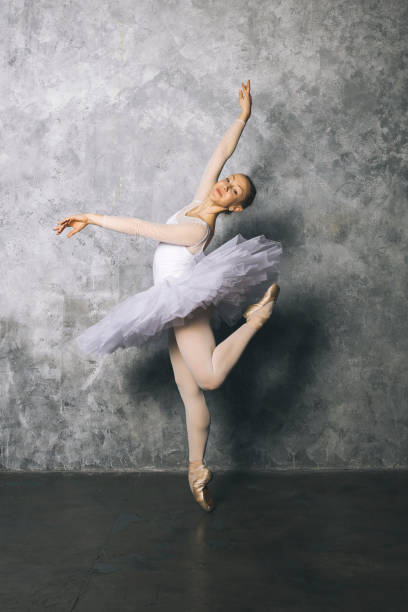 istock Pretty young ballerina dancer dancing classical ballet against rustic wall 1218166663