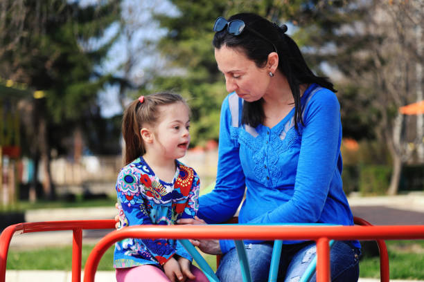 istock Mother and her daughter having fun in a playground 1218167612