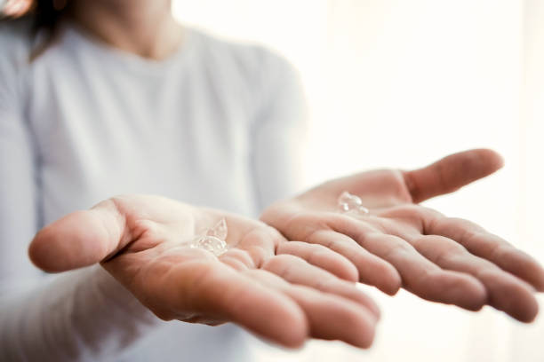 Young woman applying antibacterial sanitize gel on both hands Young woman applying antibacterial sanitize gel on hands pre press stock pictures, royalty-free photos & images