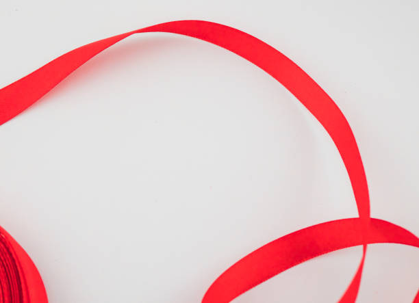istock close up of a red ribbon on white background 1218168325