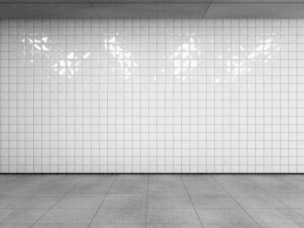 Subway station interior. Abstract urban space, empty white tiled wall with concrete floor and ceiling. Side view with copy space to your advertision. Mock up. 3d render. underground stock pictures, royalty-free photos & images