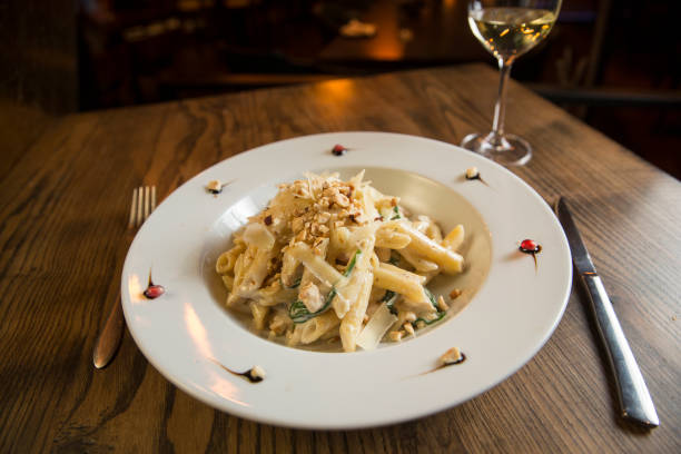 istock Penne with chicken, spinach and hazelnut in parmesan sauce 1218171012