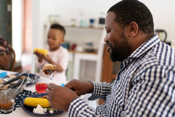 istock Side view father eating healthy lunch with family 1218171264