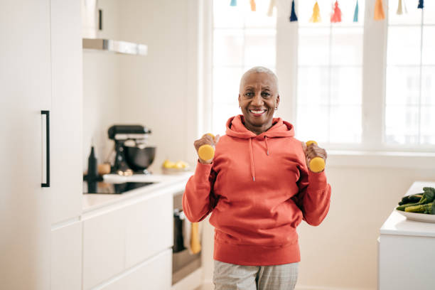 istock Senior women exercising at home 1218172567