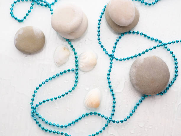 istock blue beads on white stones, with drops of water 1218175816